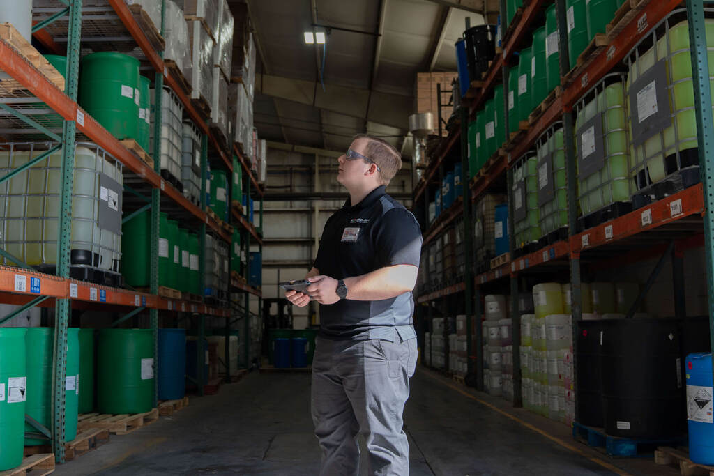 Warehouse manager checking stock on shelves